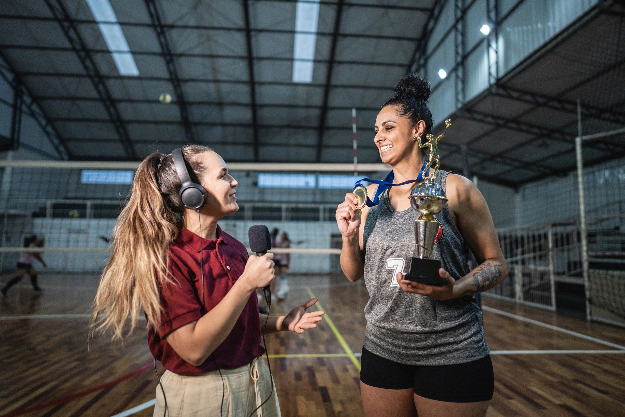 Sports reporter interviewing a volleyball player after a match
